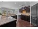Spacious kitchen with dark wood cabinets, granite countertops, and hardwood floors at 1035 Ivey Ct, Indian Land, SC 29707