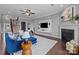 Comfortable living space featuring a cozy fireplace, mounted television, staircase, and stylish contemporary decor at 1035 Ivey Ct, Indian Land, SC 29707