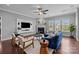 Cozy living room featuring a fireplace, mounted TV, plush seating, and ample natural light from multiple windows at 1035 Ivey Ct, Indian Land, SC 29707