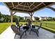 Covered patio area featuring a fire pit and outdoor seating, perfect for relaxation and gatherings at 1035 Ivey Ct, Indian Land, SC 29707