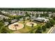 Community playground and pool area with mature trees, surrounded by well-maintained lawns and sidewalks at 1035 Ivey Ct, Indian Land, SC 29707