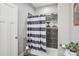 Modern bathroom features a tiled shower with blue and white striped curtain at 105 Gold Run Ct, Kings Mountain, NC 28086