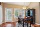 Bright dining area with a dark wood table, contemporary lighting, and access to the outdoor area at 105 Gold Run Ct, Kings Mountain, NC 28086