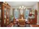 Bright dining room with a round wooden table, stylish chandelier, and ample natural light at 105 Gold Run Ct, Kings Mountain, NC 28086