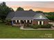 Charming brick home featuring a welcoming front porch, manicured lawn, and a well-maintained landscape at 105 Gold Run Ct, Kings Mountain, NC 28086