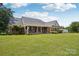 Well-maintained brick home with a spacious front yard, mature trees, and a welcoming front porch at 105 Gold Run Ct, Kings Mountain, NC 28086