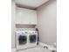 The laundry room has a front load washer and dryer, tile floors, and white cabinets at 105 Gold Run Ct, Kings Mountain, NC 28086