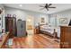 Comfortable main bedroom featuring hardwood floors, a ceiling fan, and an en-suite bathroom at 105 Gold Run Ct, Kings Mountain, NC 28086