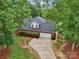 Aerial view of a brick home featuring a well-manicured yard and driveway at 105 Prairie Rose Ct, Waxhaw, NC 28173