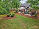 This backyard boasts a patio with outdoor furniture, a grill, and plenty of green space at 105 Prairie Rose Ct, Waxhaw, NC 28173
