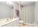 Clean bathroom featuring a vanity with sink, toilet, and shower with colorful patterned curtain at 105 Prairie Rose Ct, Waxhaw, NC 28173