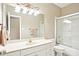 Clean bathroom with a single sink vanity, large mirror and a shower with glass door at 105 Prairie Rose Ct, Waxhaw, NC 28173