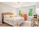 Comfortable bedroom with natural light from two windows, a ceiling fan, and stylish decor at 105 Prairie Rose Ct, Waxhaw, NC 28173