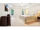 Bright bedroom with tray ceiling, carpet, and a large TV mounted on the wall at 105 Prairie Rose Ct, Waxhaw, NC 28173