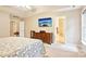 Bedroom with TV, ceiling fan, carpet, and ensuite bathroom entrance at 105 Prairie Rose Ct, Waxhaw, NC 28173