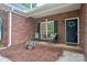 Cozy front porch adorned with a wreath, rocking chairs, and a decorative flower pot, inviting relaxation at 105 Prairie Rose Ct, Waxhaw, NC 28173