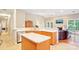 Kitchen with island, stainless steel dishwasher, and view into the living room at 105 Prairie Rose Ct, Waxhaw, NC 28173