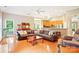 Spacious living room featuring hardwood floors, a vaulted ceiling, and an open-concept layout at 105 Prairie Rose Ct, Waxhaw, NC 28173