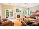 Comfortable living room with a fireplace, hardwood floors, and French doors to the backyard at 105 Prairie Rose Ct, Waxhaw, NC 28173