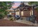 Inviting patio area with a pergola, comfortable seating, and a grill, ideal for outdoor entertaining at 105 Prairie Rose Ct, Waxhaw, NC 28173