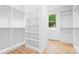 Walk-in closet with custom shelving, hanging rods, and a window for natural light at 106 Arbor Dr, Waxhaw, NC 28173