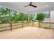 Large covered deck with ceiling fan offering scenic views of the surrounding landscape at 106 Arbor Dr, Waxhaw, NC 28173