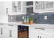 Modern kitchen features white cabinetry, marble countertops, and a stylish blue tile backsplash at 106 Arbor Dr, Waxhaw, NC 28173