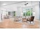 Spacious living room with an open floor plan and large windows showcasing lush greenery at 106 Arbor Dr, Waxhaw, NC 28173