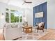 Bright living room featuring a modern fireplace and large windows with scenic outdoor views at 106 Arbor Dr, Waxhaw, NC 28173
