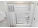 Bright bathroom featuring a white shower tub with a decorative shower curtain and wall shelving at 109 Mac Aly, Cramerton, NC 28032