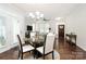Bright dining area features a modern chandelier and access to the entry way, living area, and an exterior door at 109 Mac Aly, Cramerton, NC 28032