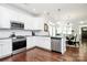Modern kitchen with white cabinetry, stainless steel appliances, and granite countertops at 109 Mac Aly, Cramerton, NC 28032