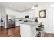 Well-lit kitchen with white cabinets, stainless steel appliances, and a breakfast bar at 109 Mac Aly, Cramerton, NC 28032