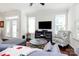 Bright living room featuring hardwood floors, a comfortable sofa, and large windows at 109 Mac Aly, Cramerton, NC 28032