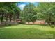 An expansive green backyard has plenty of space for outdoor activities at 114 Sardis Plantation Dr, Matthews, NC 28105