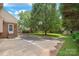 A spacious backyard features an extra parking pad, shed, and mature trees at 114 Sardis Plantation Dr, Matthews, NC 28105