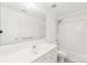 A bright bathroom featuring a shower-tub combo, and large mirror at 114 Sardis Plantation Dr, Matthews, NC 28105