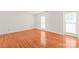 Bright, empty bedroom features hardwood flooring and neutral paint, with two windows overlooking the front yard at 114 Sardis Plantation Dr, Matthews, NC 28105