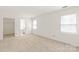 Bright bedroom featuring neutral carpet, two windows, and an ensuite bathroom at 114 Sardis Plantation Dr, Matthews, NC 28105
