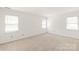 Neutral bedroom features two large windows, and neutral carpet at 114 Sardis Plantation Dr, Matthews, NC 28105