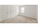 Neutral bedroom featuring neutral carpet, two closets, and a window at 114 Sardis Plantation Dr, Matthews, NC 28105
