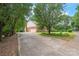 A long driveway leads to the brick home with an attached garage at 114 Sardis Plantation Dr, Matthews, NC 28105
