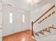 Bright foyer with hardwood floors, staircase, and white trim, leading to the front entrance at 114 Sardis Plantation Dr, Matthews, NC 28105