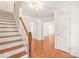 Bright foyer with hardwood floors, staircase, and white trim, leading to open living spaces at 114 Sardis Plantation Dr, Matthews, NC 28105