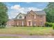 Charming two-story brick home featuring a well-manicured lawn and a classic architectural design at 114 Sardis Plantation Dr, Matthews, NC 28105