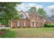 Charming two-story brick home featuring a well-manicured lawn and a classic architectural design at 114 Sardis Plantation Dr, Matthews, NC 28105