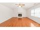 Bright living room featuring a white brick fireplace, high ceilings, and ample natural light with hardwood floors at 114 Sardis Plantation Dr, Matthews, NC 28105