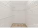 Walk-in closet with custom white wire rack shelves and neutral carpet at 114 Sardis Plantation Dr, Matthews, NC 28105