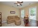 Cozy room with comfortable sofa, fan, and natural light at 11607 Meetinghouse Dr, Cornelius, NC 28031