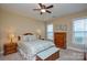 Bedroom with coordinating furniture set, fan, and ample natural light at 11607 Meetinghouse Dr, Cornelius, NC 28031